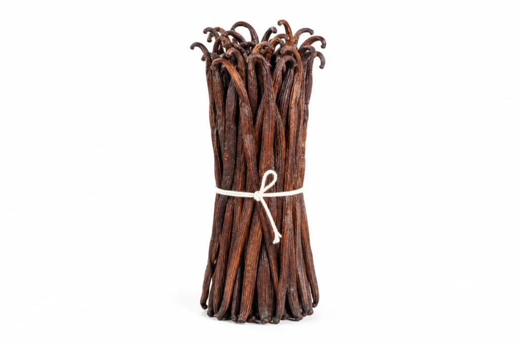 A bundle of long, wrinkled brown vanilla beans tied with twine on a white background.